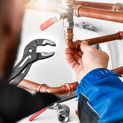 Plumbing concept or service water worker. copper pipeline with p